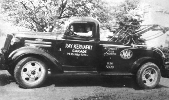 Picture of Ray Kerhaert 1st and Ray Kerhaert 2nd in an old model tow truck from Rochester NY