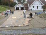 Large paverstone driveway by landscape solutions