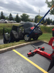 Recovery picture of SUV being winched from water-Rochester NY